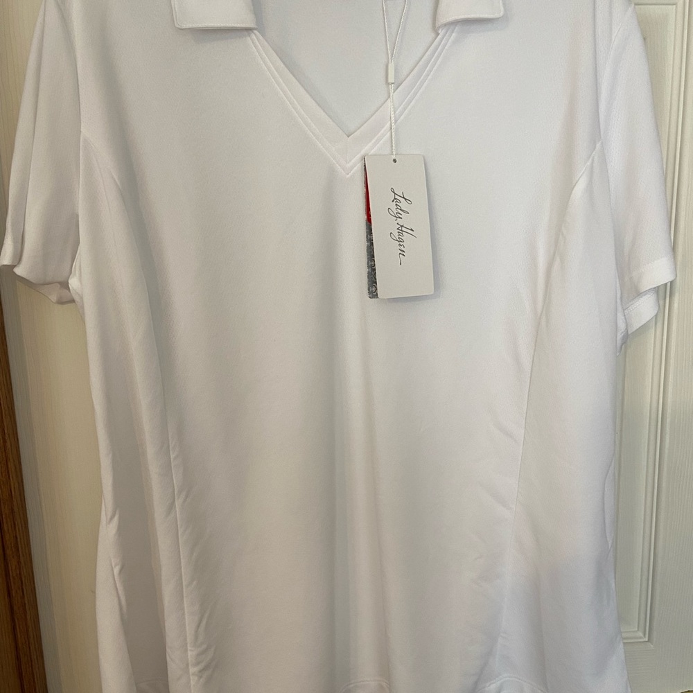 Ladies white golf shirt with v-collared neckline.